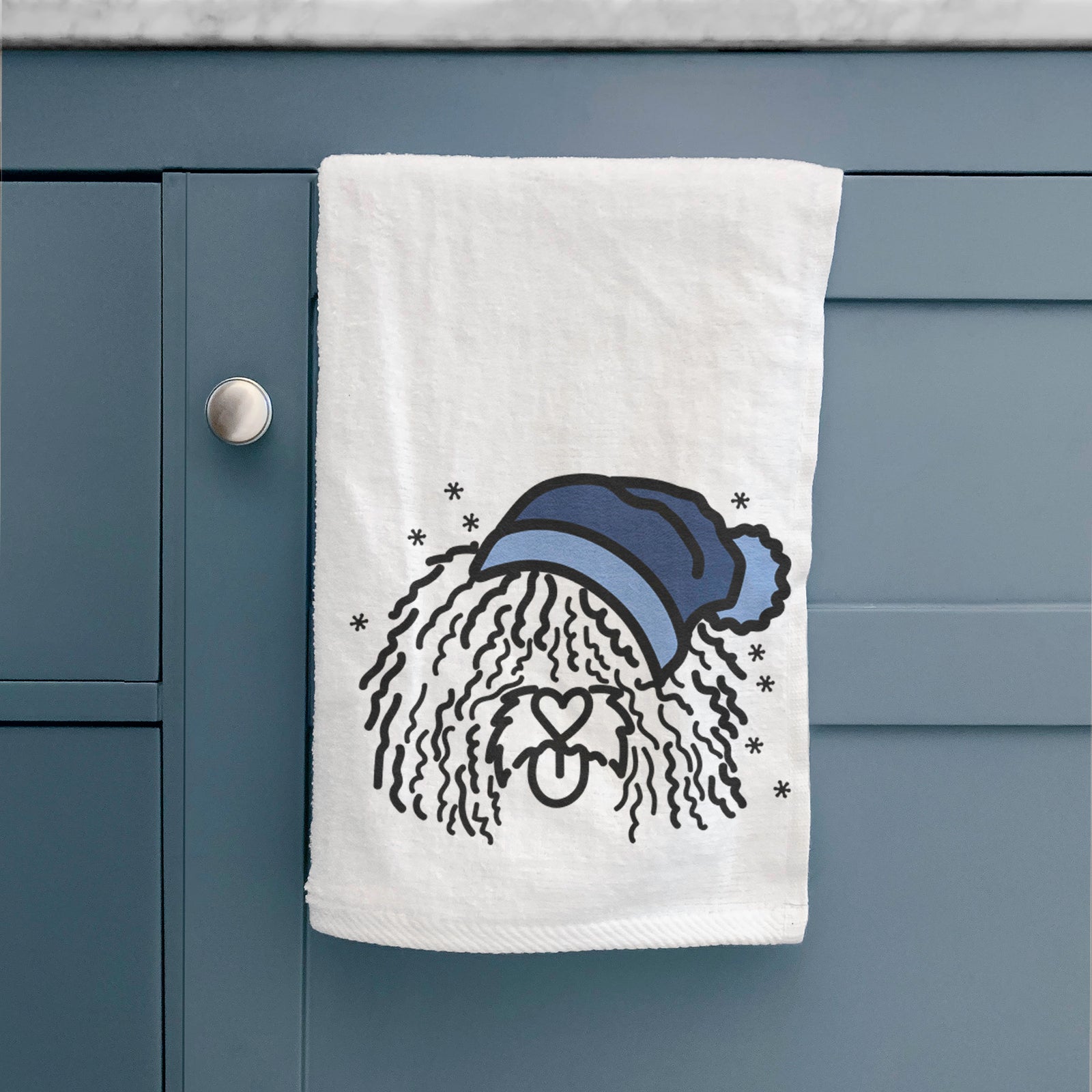 Minimalist line drawing of Alba the Spanish Water Dog wearing a winter beanie on a decorative hand towel