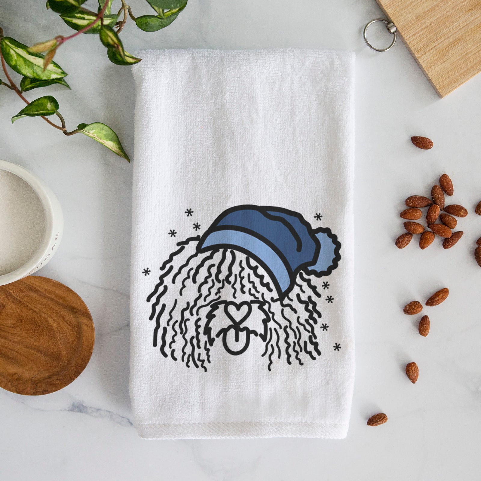 Minimalist line drawing of Alba the Spanish Water Dog wearing a winter beanie on a decorative hand towel