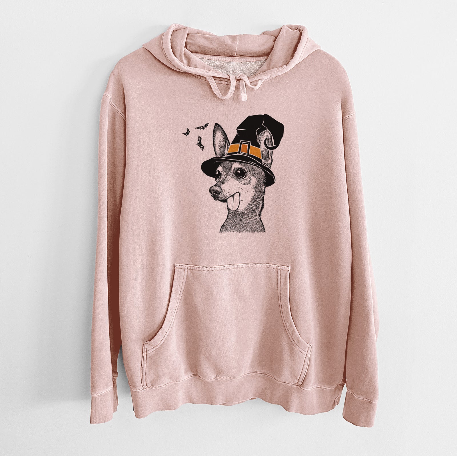 Hand-drawn sketch of Aaron the Chihuahua wearing a witch hat on a Dusty Pink Unisex pigment dyed hoodie