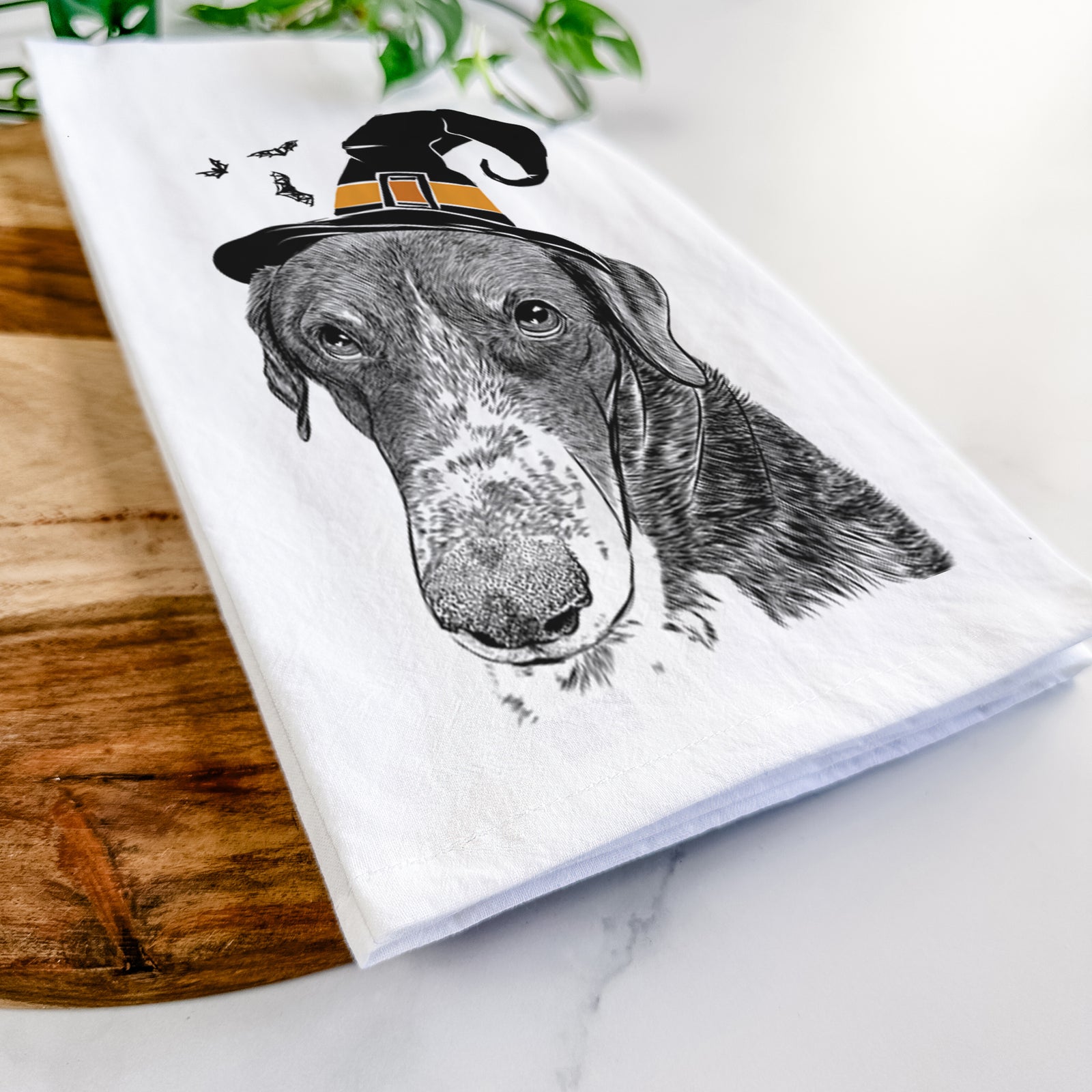 Hand-drawn sketch of Angel Orion the Mixed Breed wearing a witch hat on a tea towel