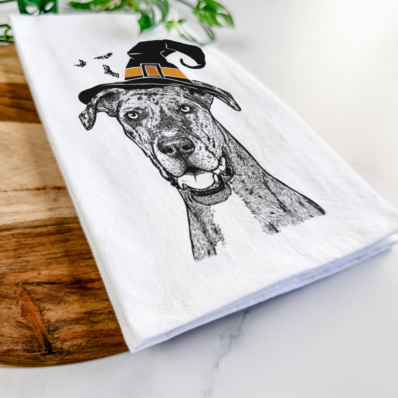 Hand-drawn sketch of Athena the Merle Great Dane wearing a witch hat on a tea towel