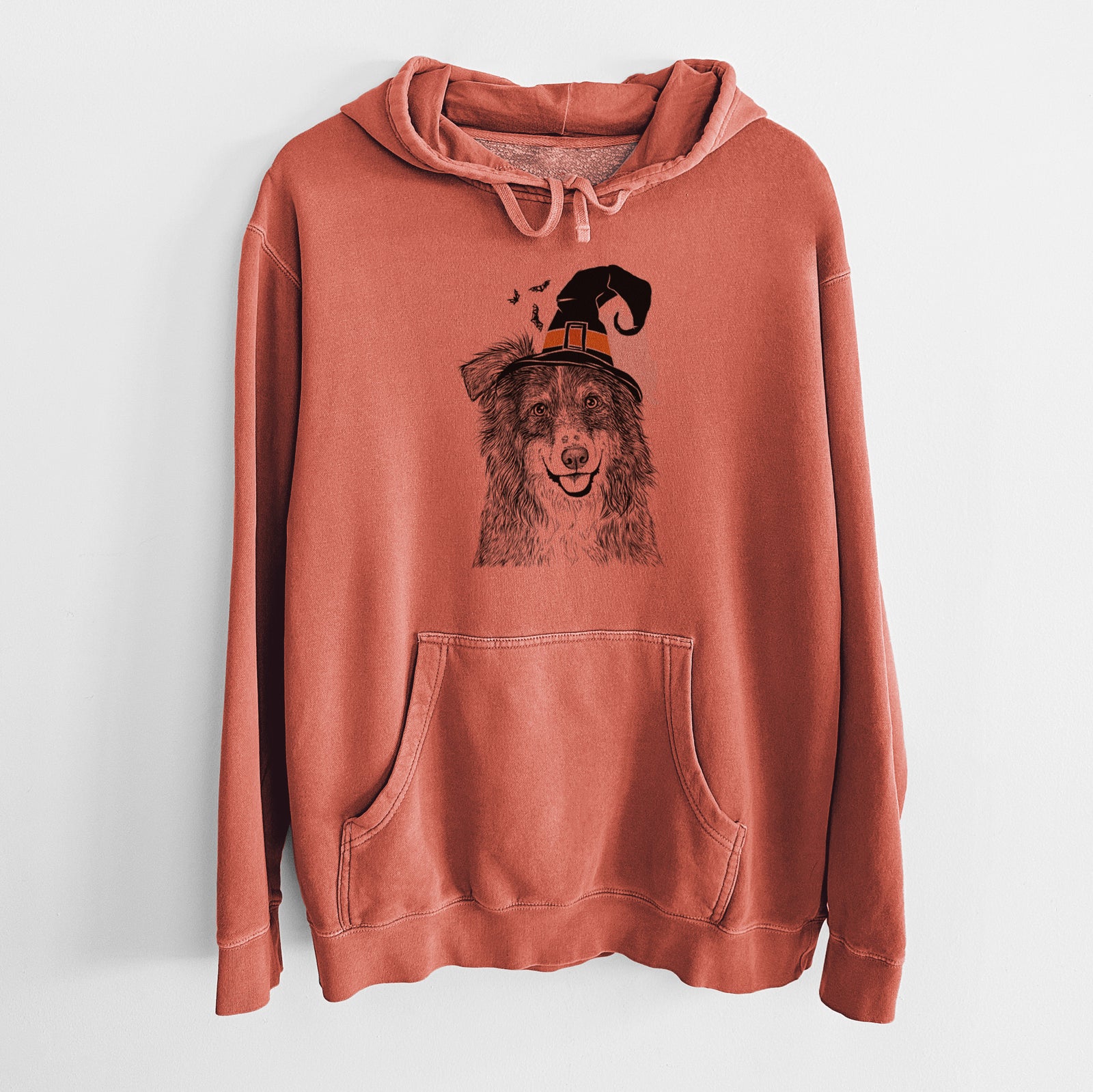 Hand-drawn sketch of Aushe the Australian Shepherd wearing a witch hat on an Amber Unisex pigment dyed hoodie