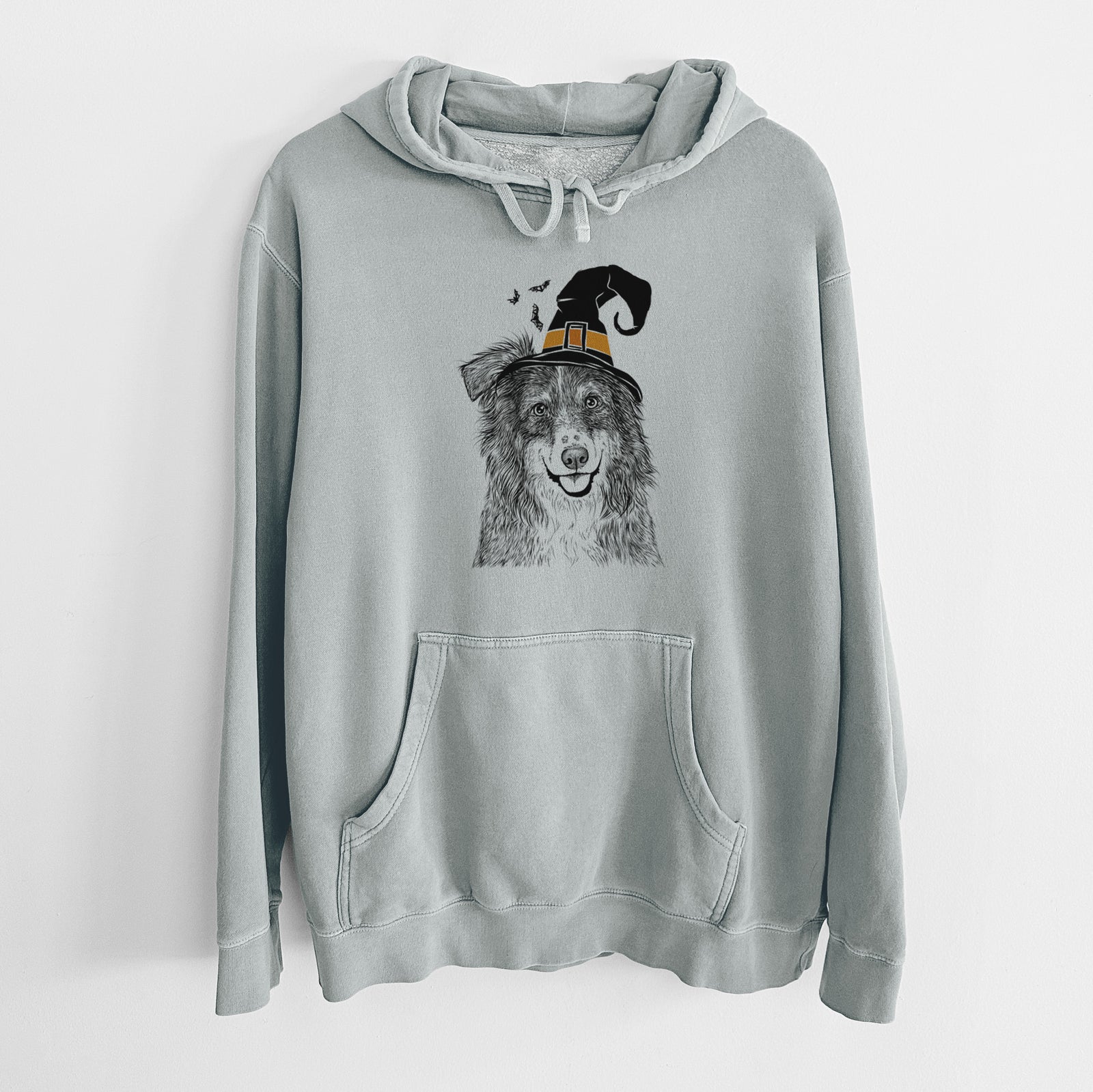 Hand-drawn sketch of Aushe the Australian Shepherd wearing a witch hat on a Sage Unisex pigment dyed hoodie