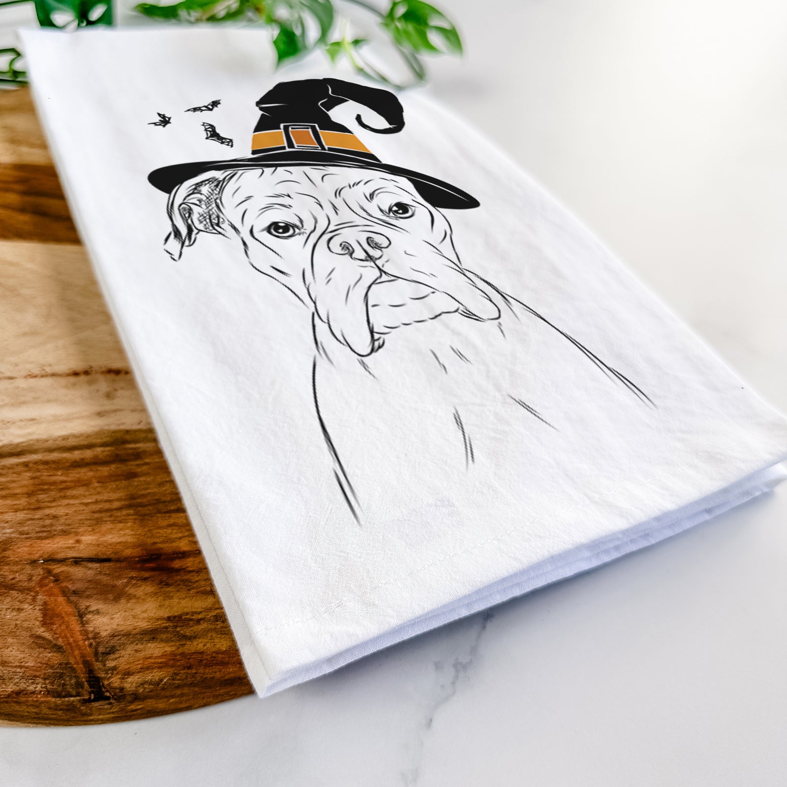 Hand-drawn sketch of Axel the Boxer wearing a witch hat on a tea towel