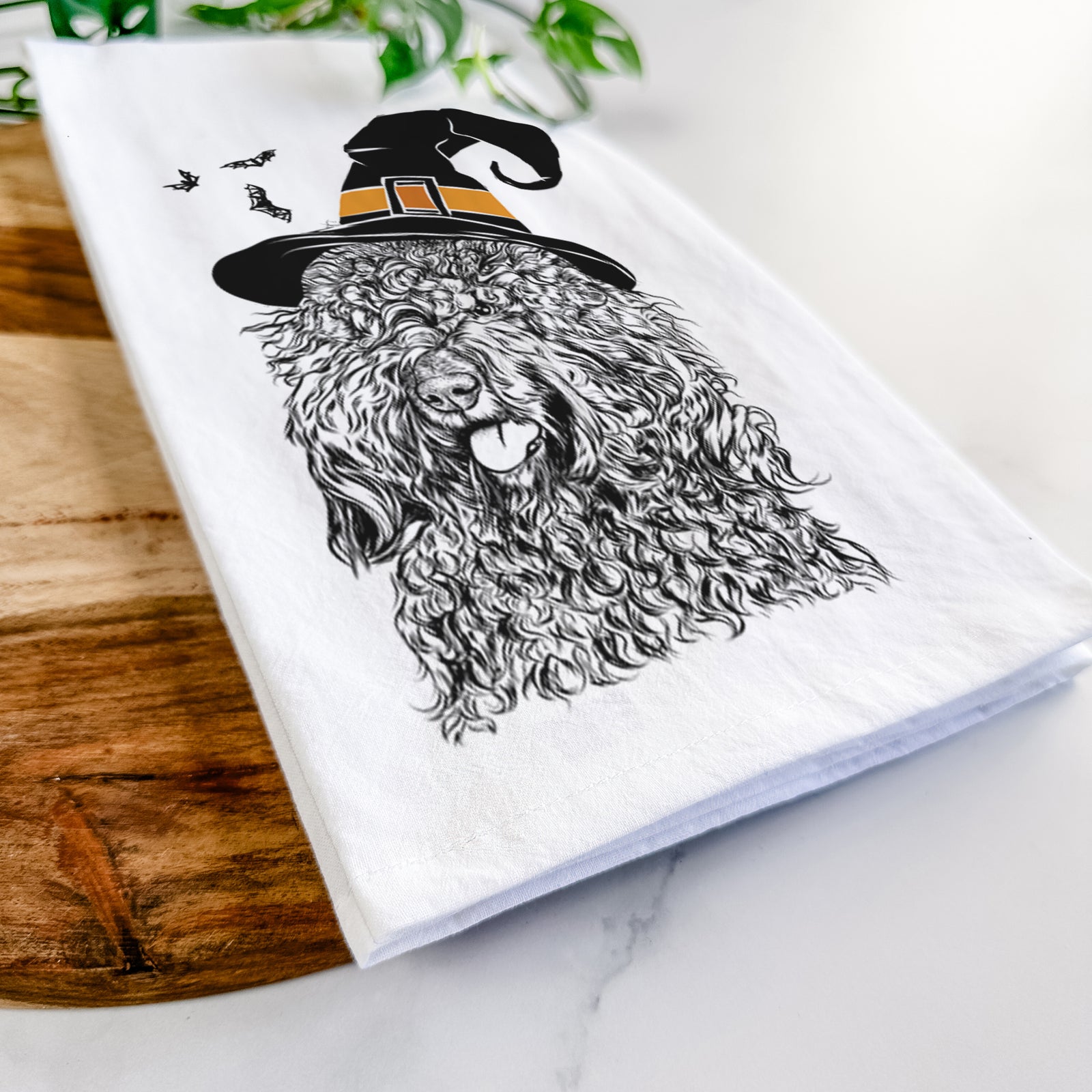 Hand-drawn sketch of Babs the Barbet wearing a witch hat on a tea towel