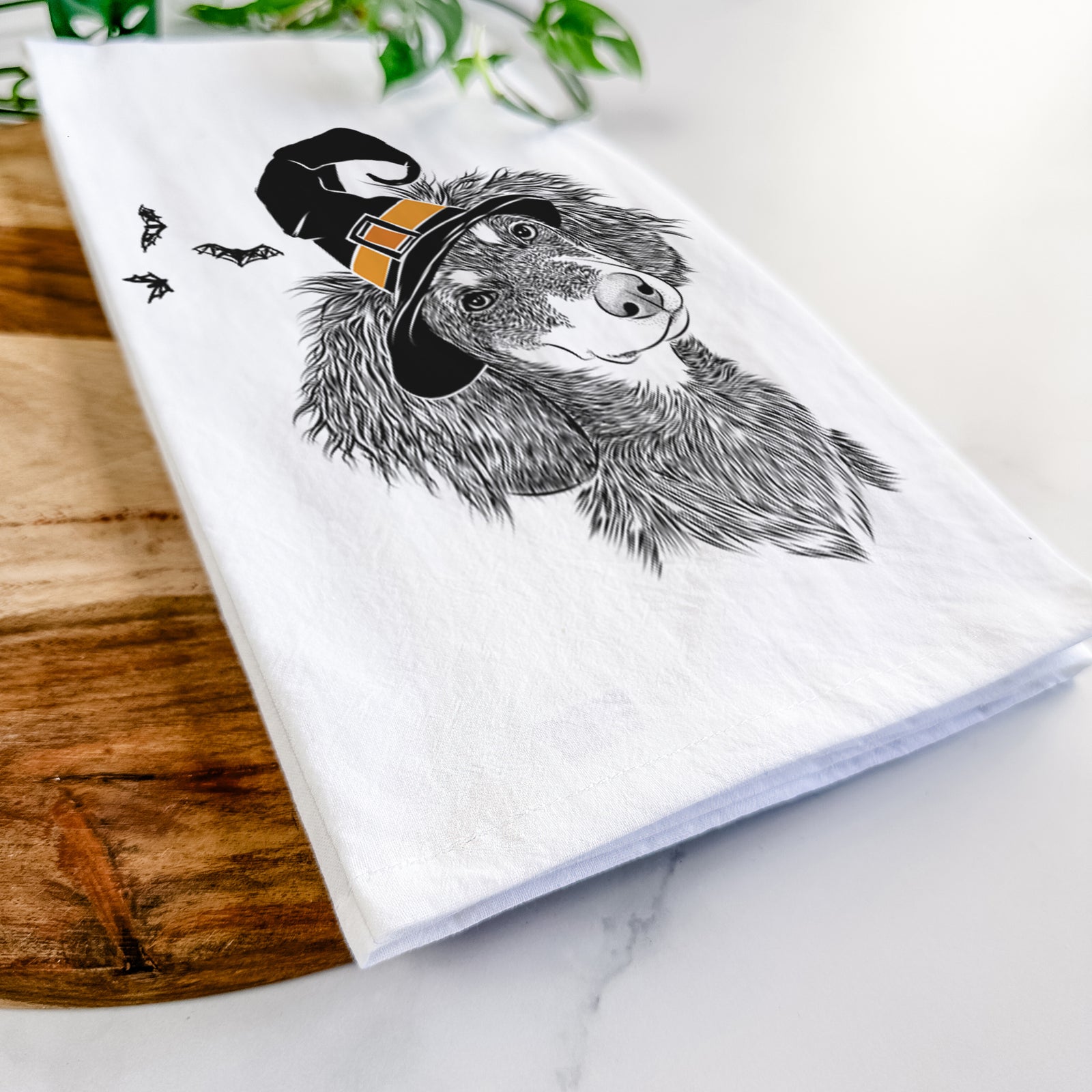 Hand-drawn sketch of Bailey the Long Haired Dachshund wearing a witch hat on a tea towel