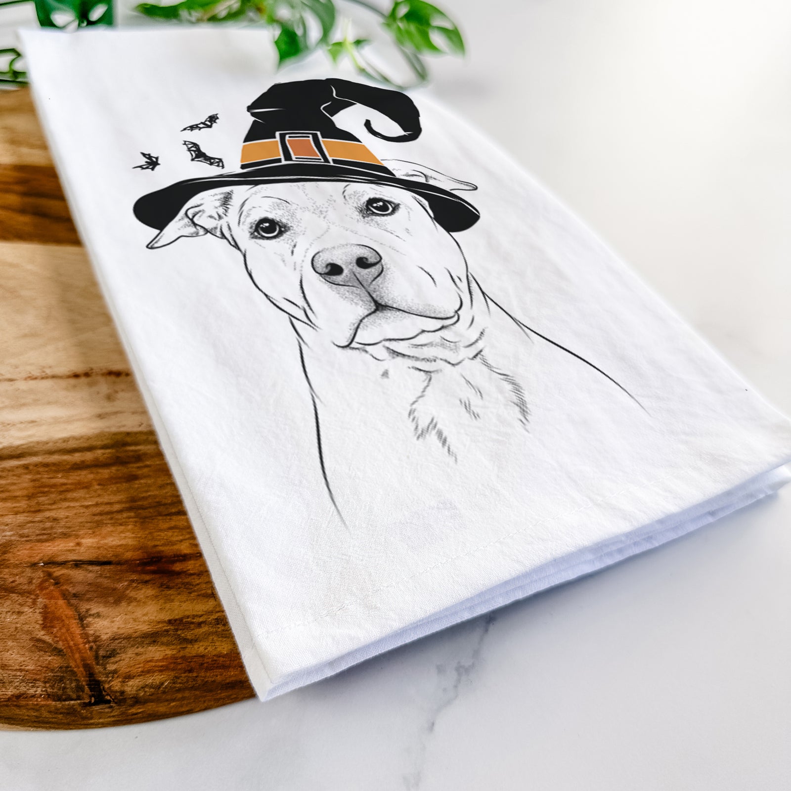 Hand-drawn sketch of Bailey the American Staffordshire Terrier wearing a witch hat on a tea towel