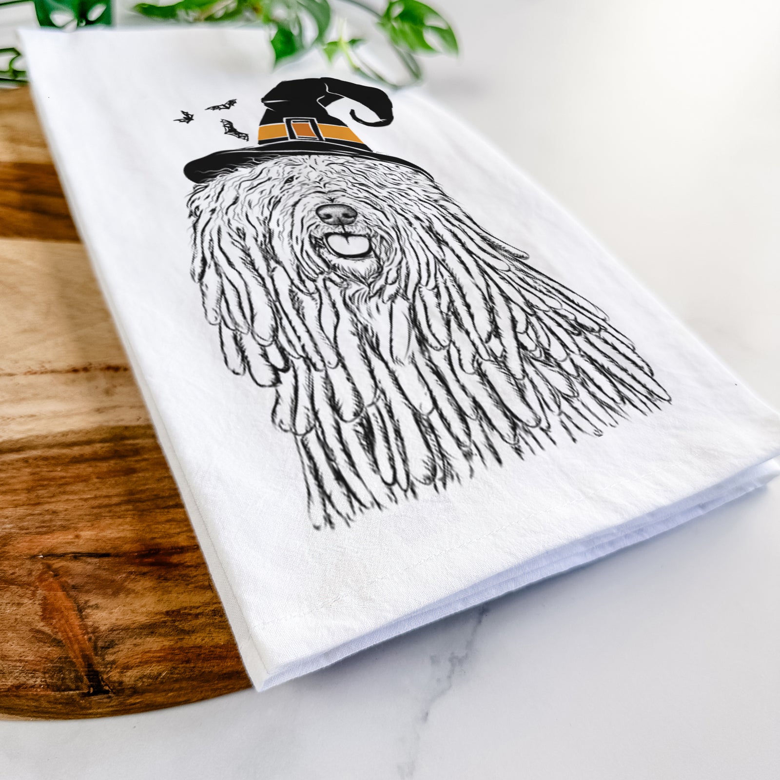 Hand-drawn sketch of Barry the Komondor wearing a witch hat on a tea towel