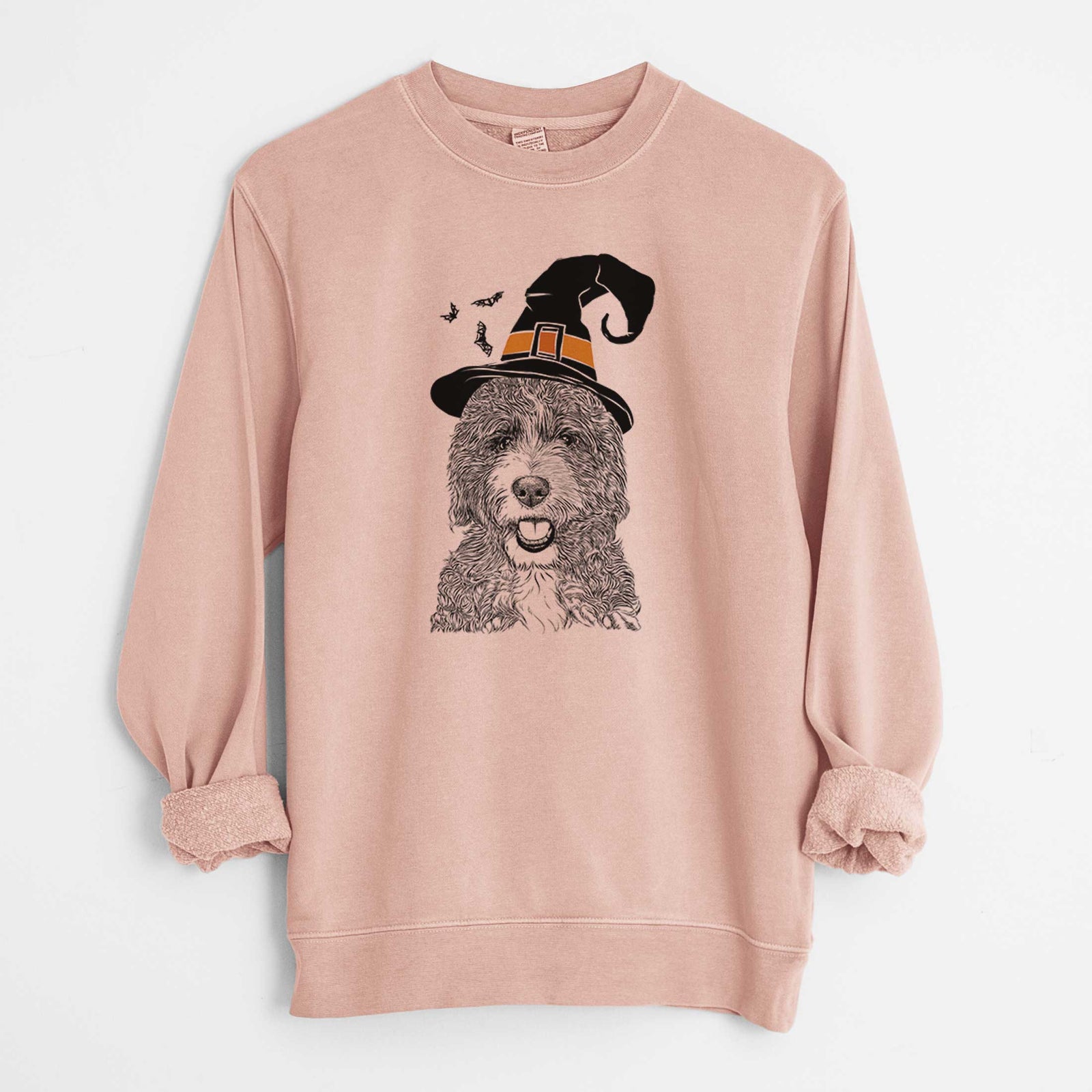 Hand-drawn sketch of Bash the Bernedoodle wearing a witch hat on a Dusty Pink Unisex pigment dyed crew sweatshirt