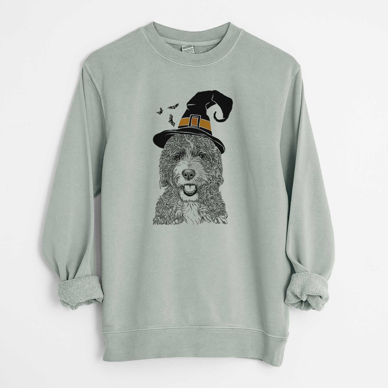 Hand-drawn sketch of Bash the Bernedoodle wearing a witch hat on a Sage Unisex pigment dyed crew sweatshirt