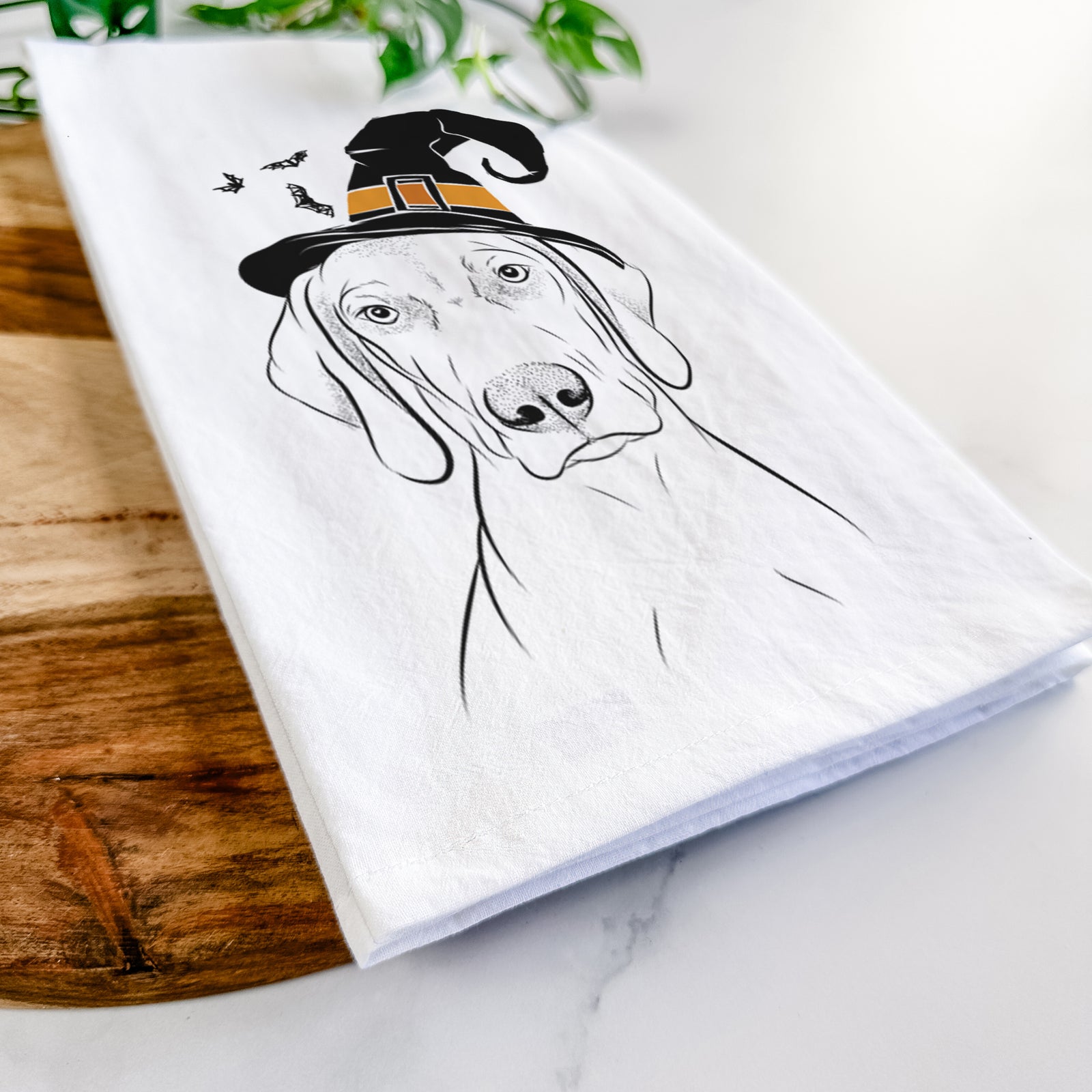 Hand-drawn sketch of Benelli the Vizsla wearing a witch hat on a tea towel