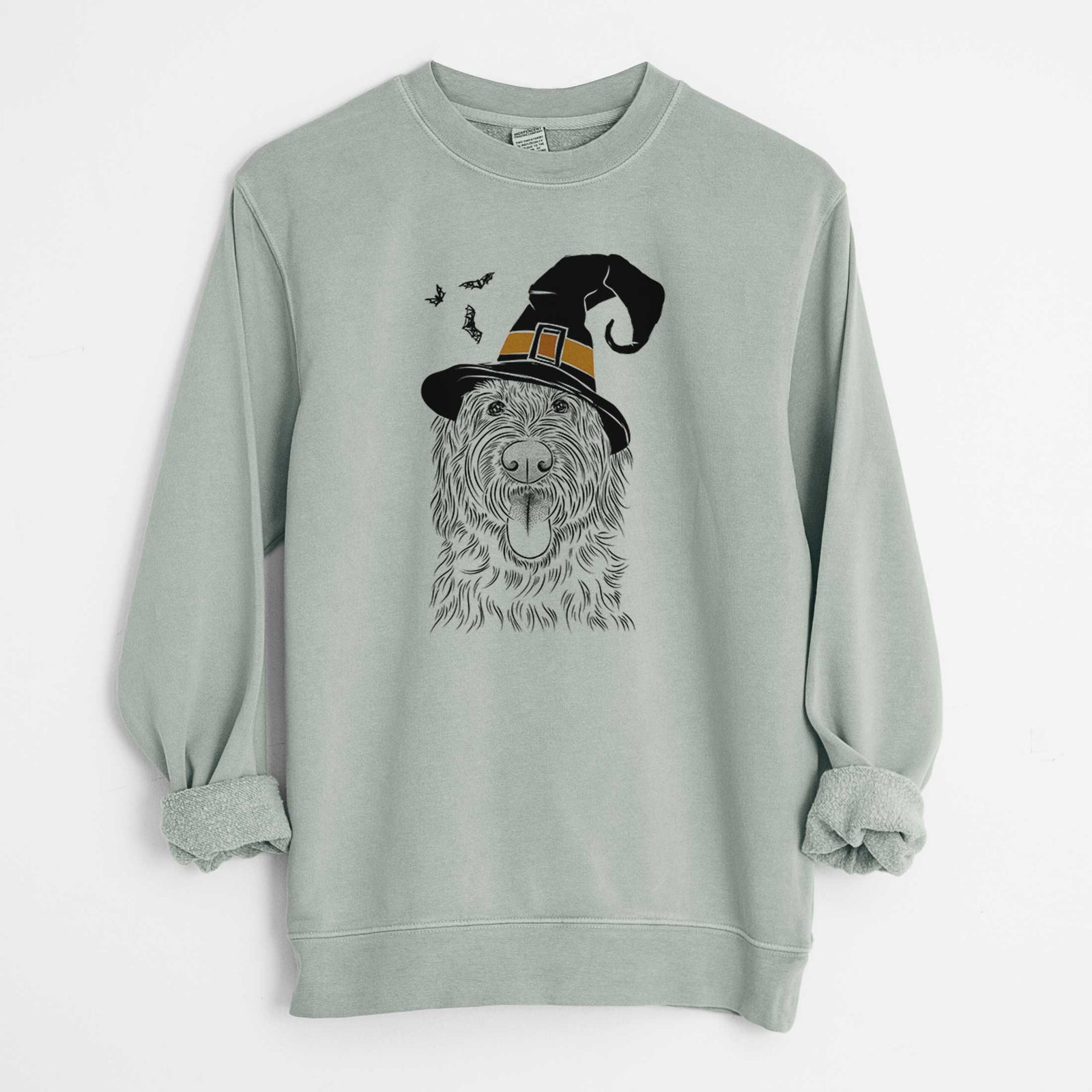 Hand-drawn sketch of Bennett the Doodle wearing a witch hat on a Sage Unisex pigment dyed crew sweatshirt
