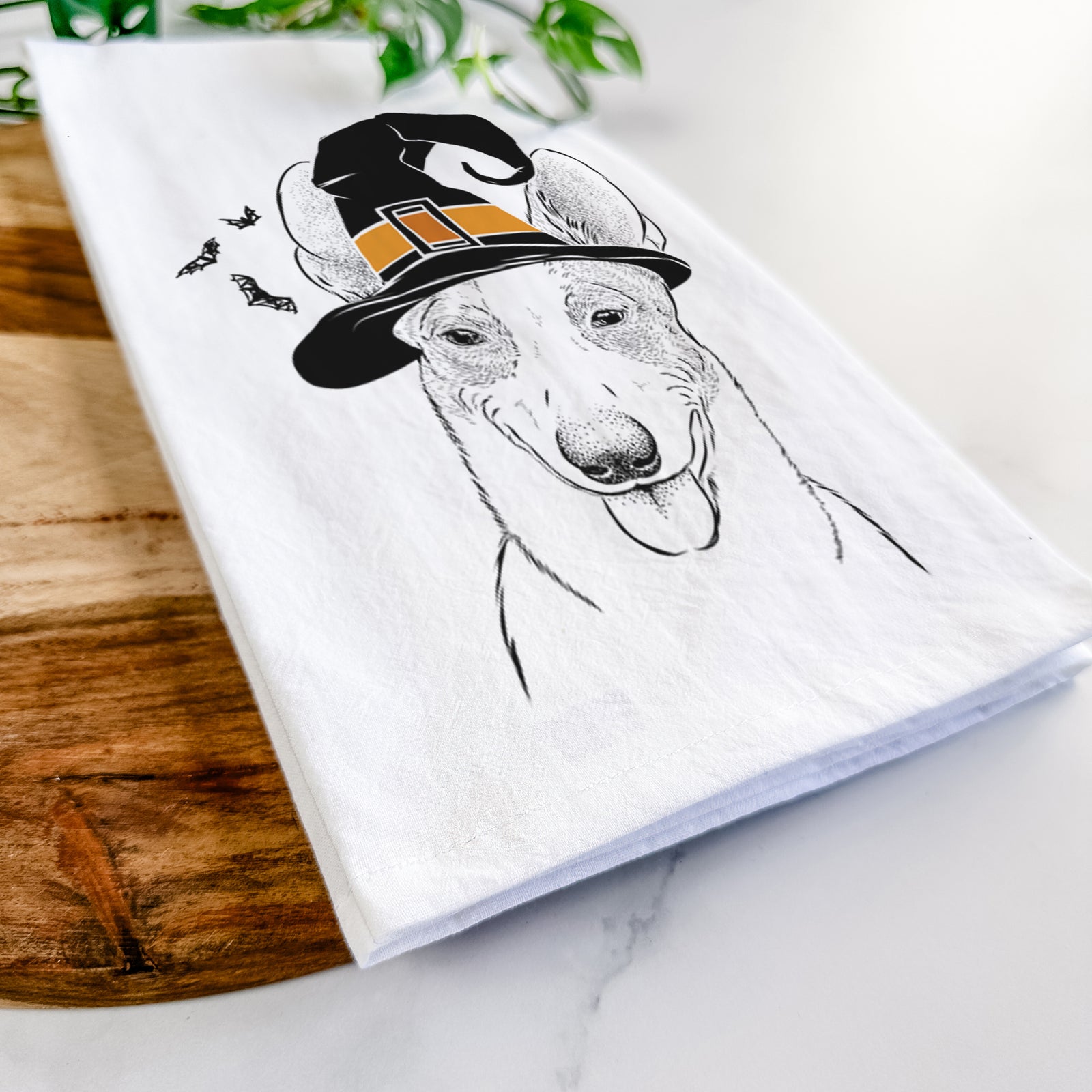 Hand-drawn sketch of Berlin the Carolina Dog wearing a witch hat on a tea towel