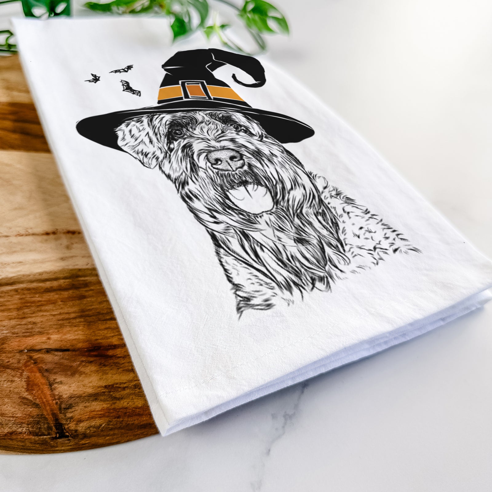 Hand-drawn sketch of Bonnie the Bouvier Des Flandres wearing a witch hat on a tea towel