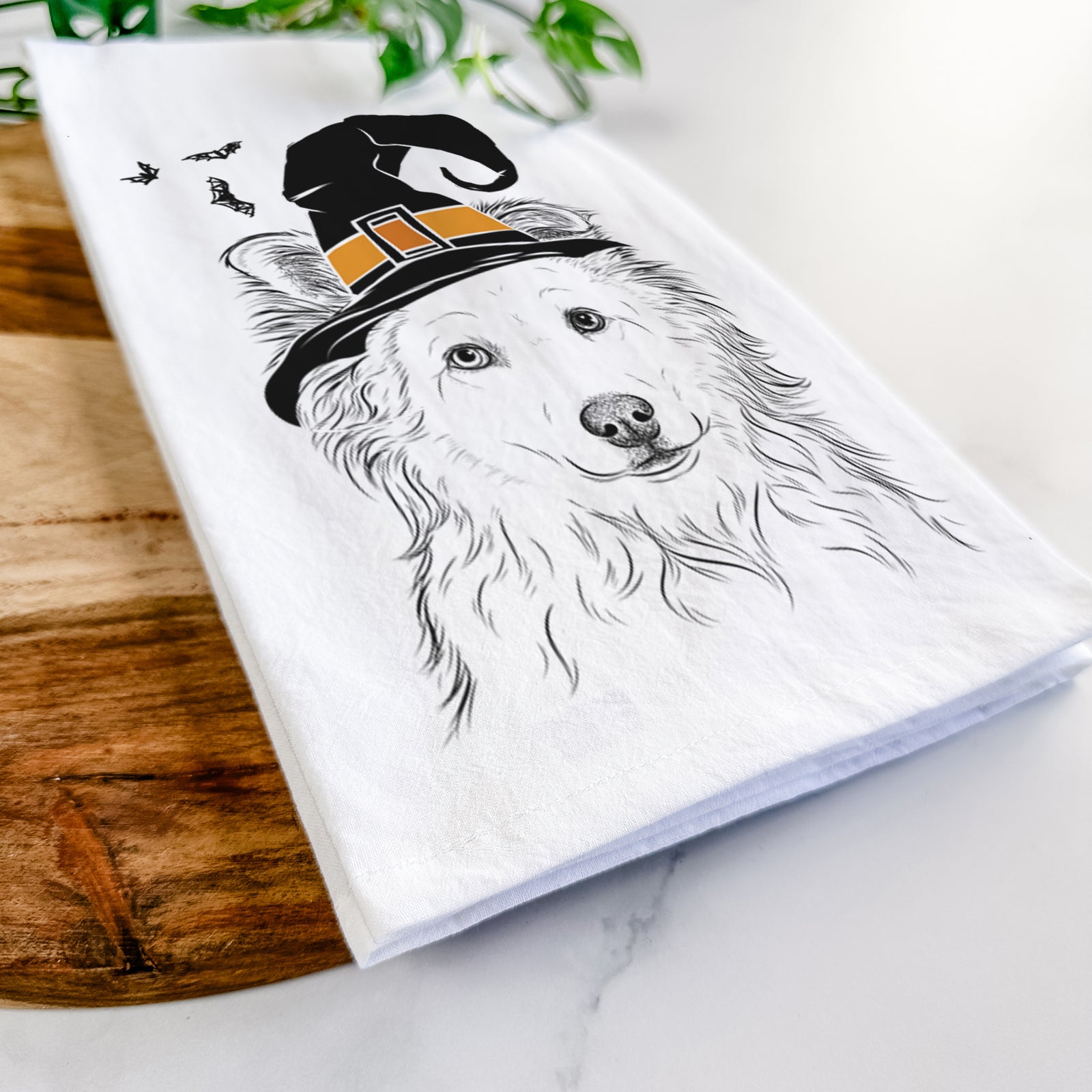 Hand-drawn sketch of Bonsai the Mixed Breed wearing a witch hat on a tea towel