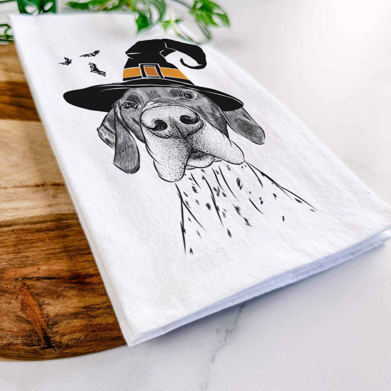 Hand-drawn sketch of Booze the German Shorthaired Pointer wearing a witch hat on a tea towel