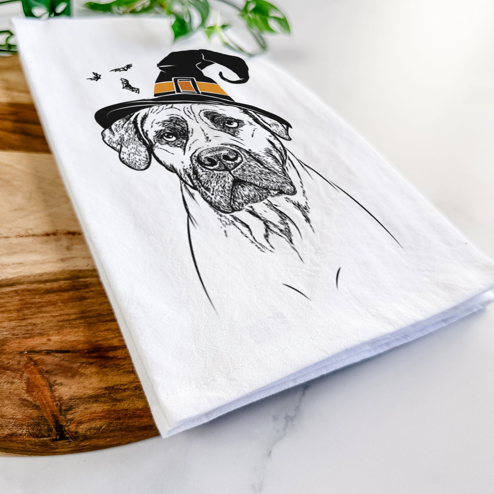 Hand-drawn sketch of Boris the Boerboel wearing a witch hat on a tea towel