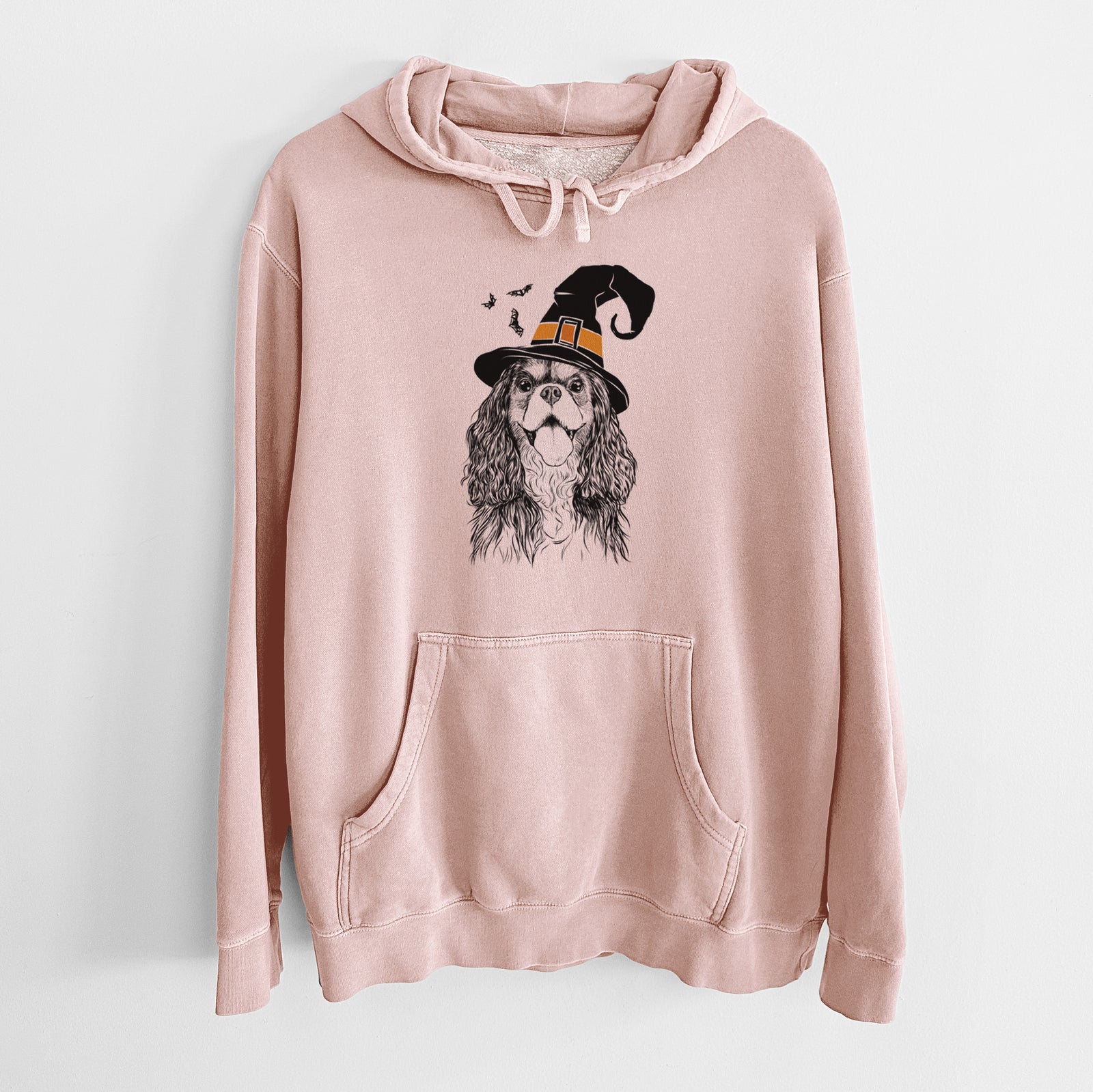 Hand-drawn sketch of Brandy the Cavalier King Charles Spaniel wearing a witch hat on a Dusty Pink Unisex pigment dyed hoodie