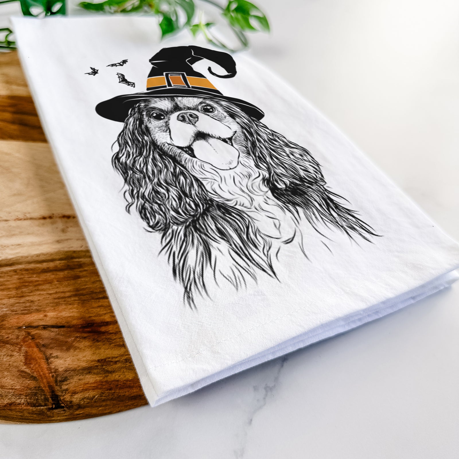 Hand-drawn sketch of Brandy the Cavalier King Charles Spaniel wearing a witch hat on a tea towel