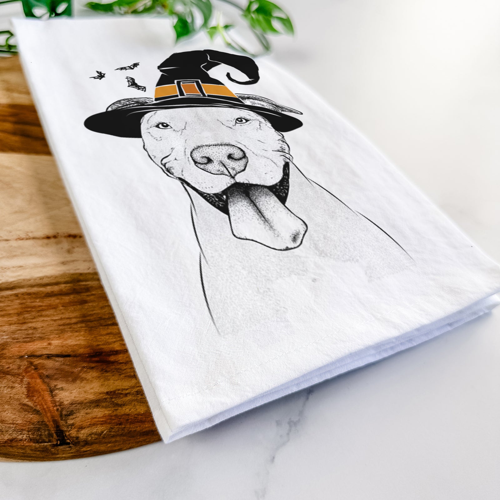 Hand-drawn sketch of Bruce the American Staffordshire Terrier wearing a witch hat on a tea towel