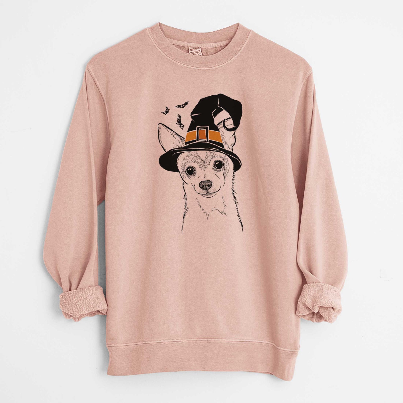 Hand-drawn sketch of Buggy the Chihuahua wearing a witch hat on a Dusty Pink Unisex pigment dyed crew sweatshirt