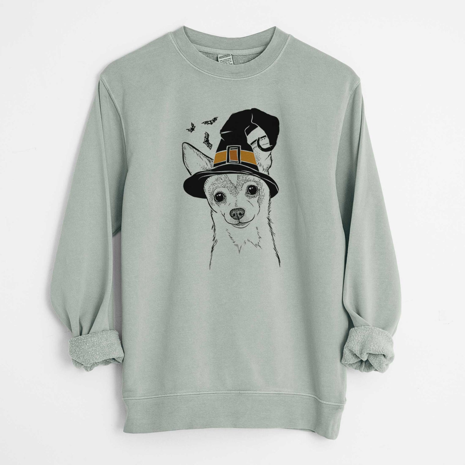 Hand-drawn sketch of Buggy the Chihuahua wearing a witch hat on a Sage Unisex pigment dyed crew sweatshirt