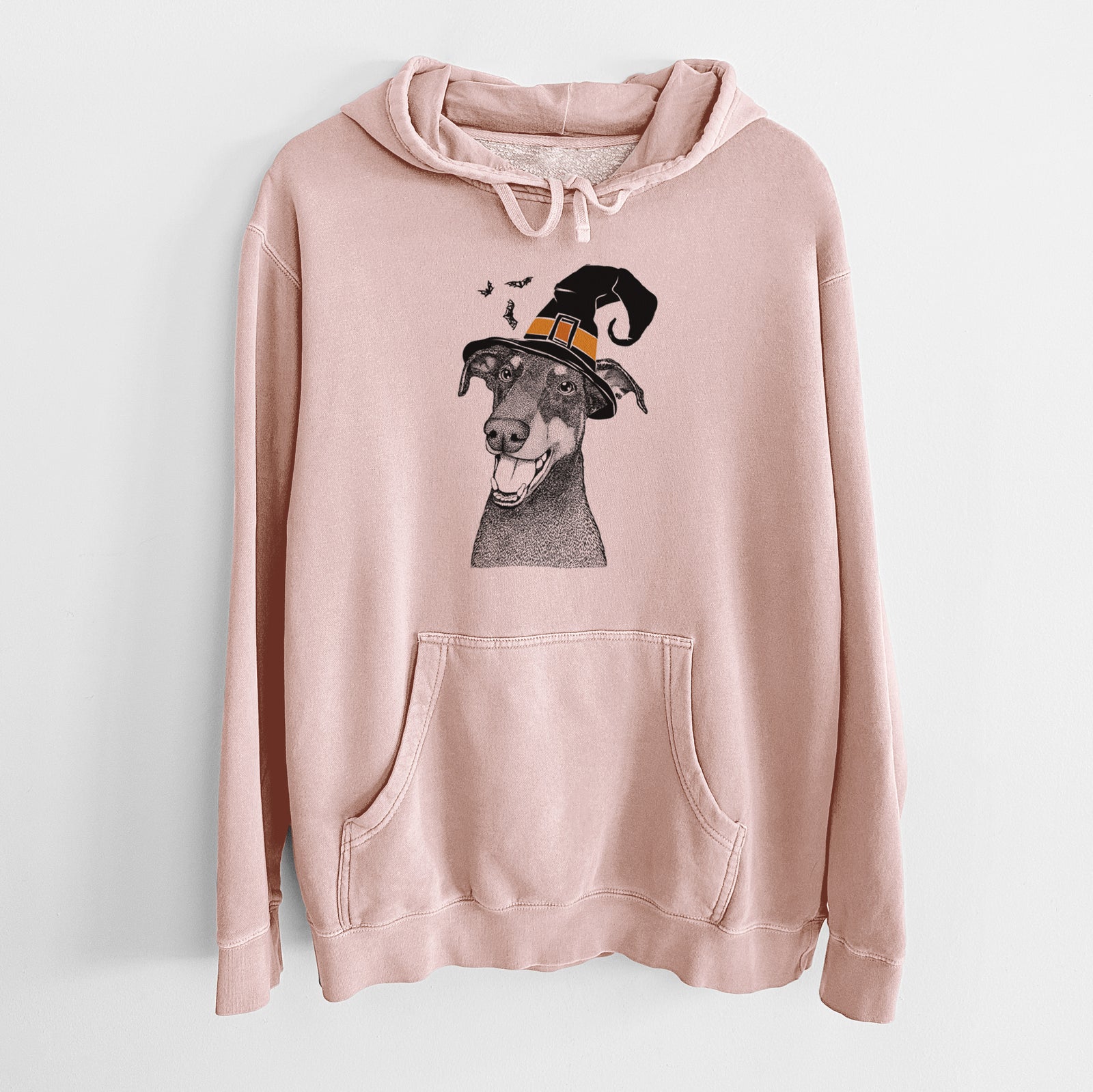 Hand-drawn sketch of Bunnie the Doberman Pinscher wearing a witch hat on a Dusty Pink Unisex pigment dyed hoodie