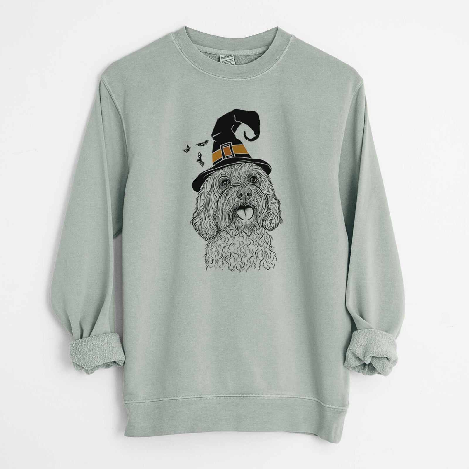 Hand-drawn sketch of Cali the Cavapoo wearing a witch hat on a Sage Unisex pigment dyed crew sweatshirt