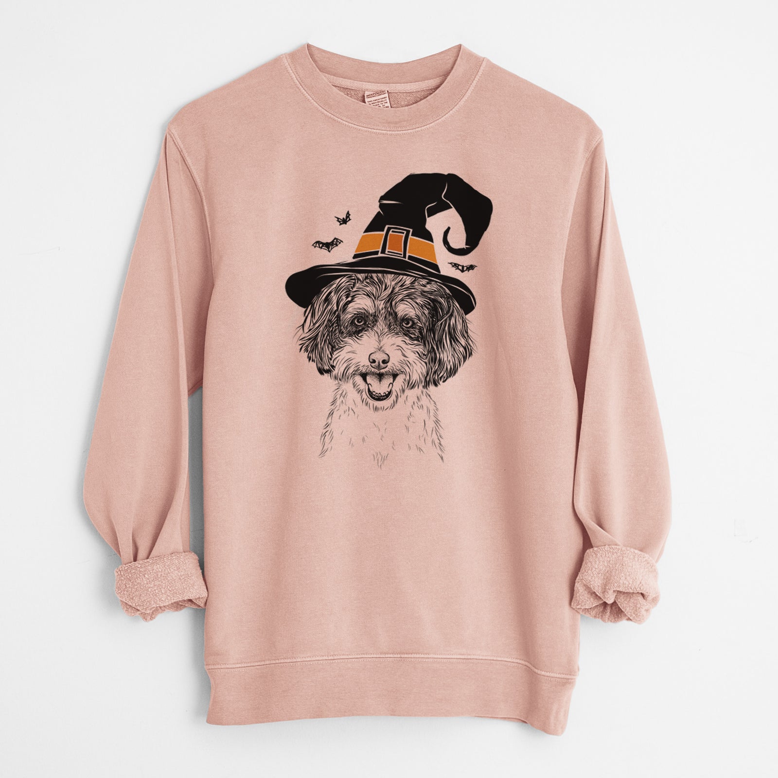 Hand-drawn sketch of Carlos the Cavapoo wearing a witch hat on a Dusty Pink Unisex pigment dyed crew sweatshirt