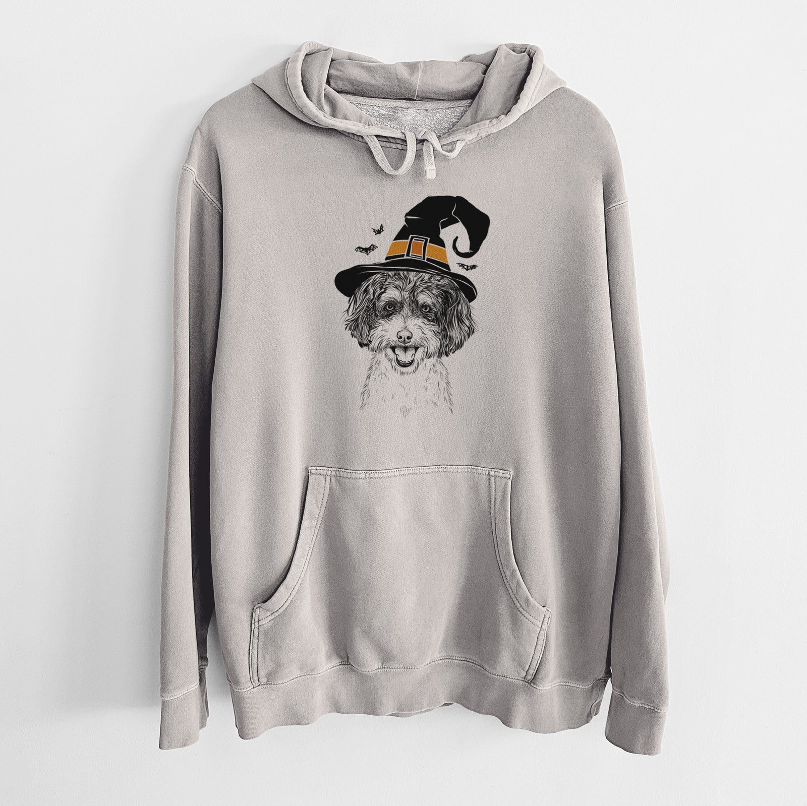 Hand-drawn sketch of Carlos the Cavapoo wearing a witch hat on a Cement Unisex pigment dyed hoodie