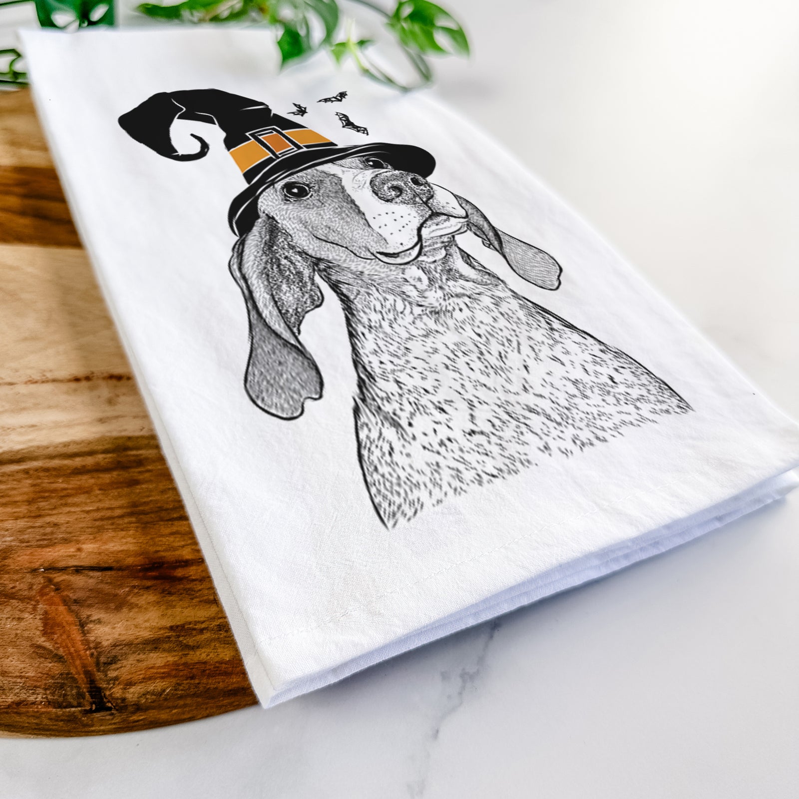 Hand-drawn sketch of Chester the Red Tick Coonhound wearing a witch hat on a tea towel