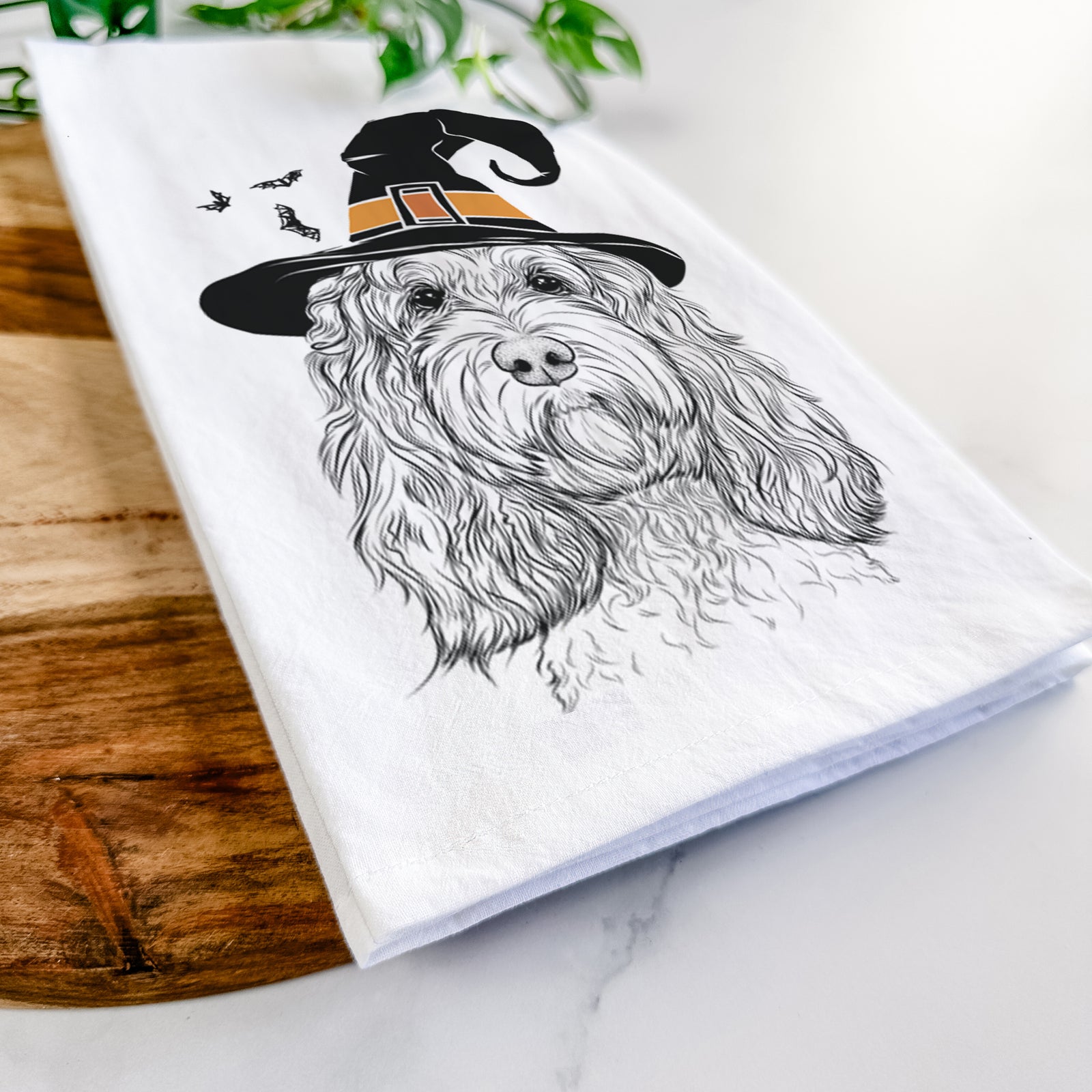 Hand-drawn sketch of Chloe the Cockapoo wearing a witch hat on a tea towel