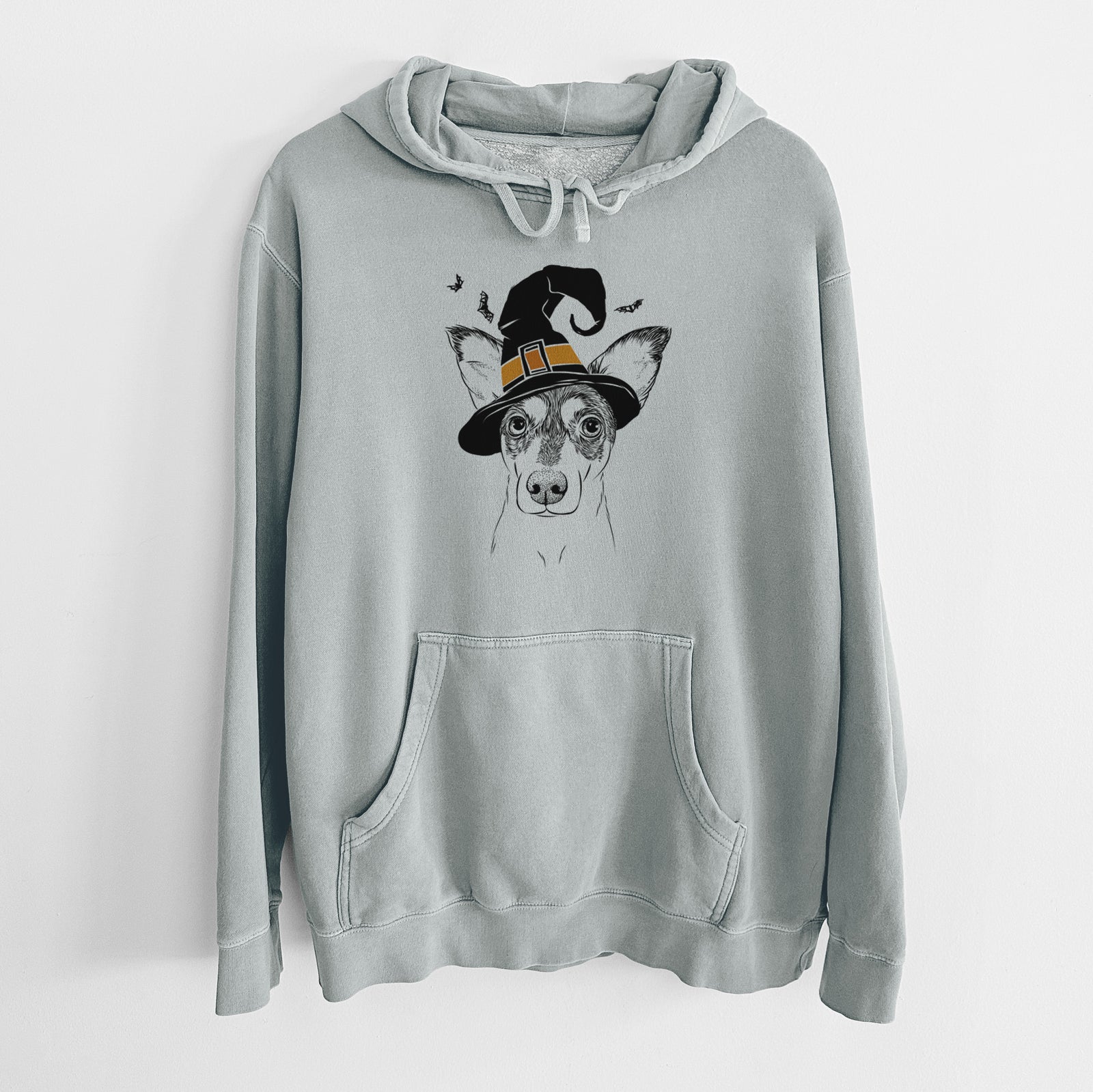 Hand-drawn sketch of Chloe the Doxie Mix wearing a witch hat on a Sage Unisex pigment dyed hoodie