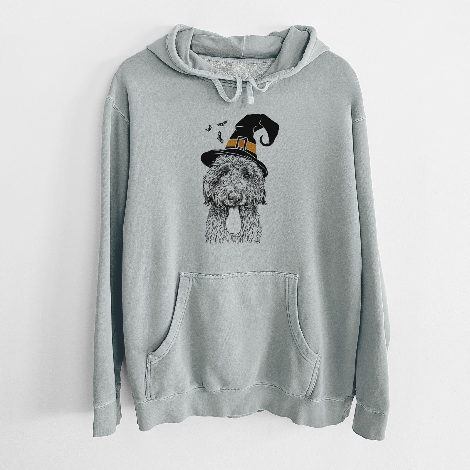 Hand-drawn sketch of CiCi Paulk the Aussiedoodle wearing a witch hat on a Sage Unisex pigment dyed hoodie