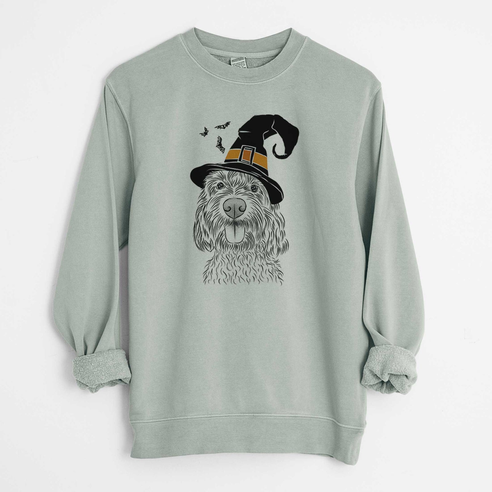 Hand-drawn sketch of Clover the Cockapoo wearing a witch hat on a Sage Unisex pigment dyed crew sweatshirt