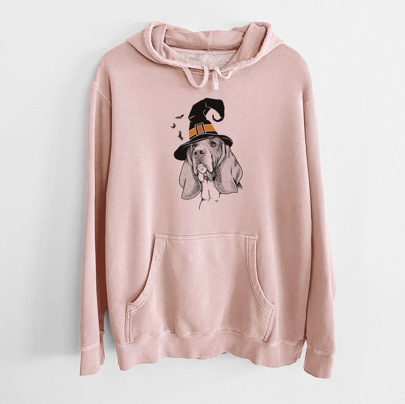 Hand-drawn sketch of Cooper the Basset Hound wearing a witch hat on a Dusty Pink Unisex pigment dyed hoodie