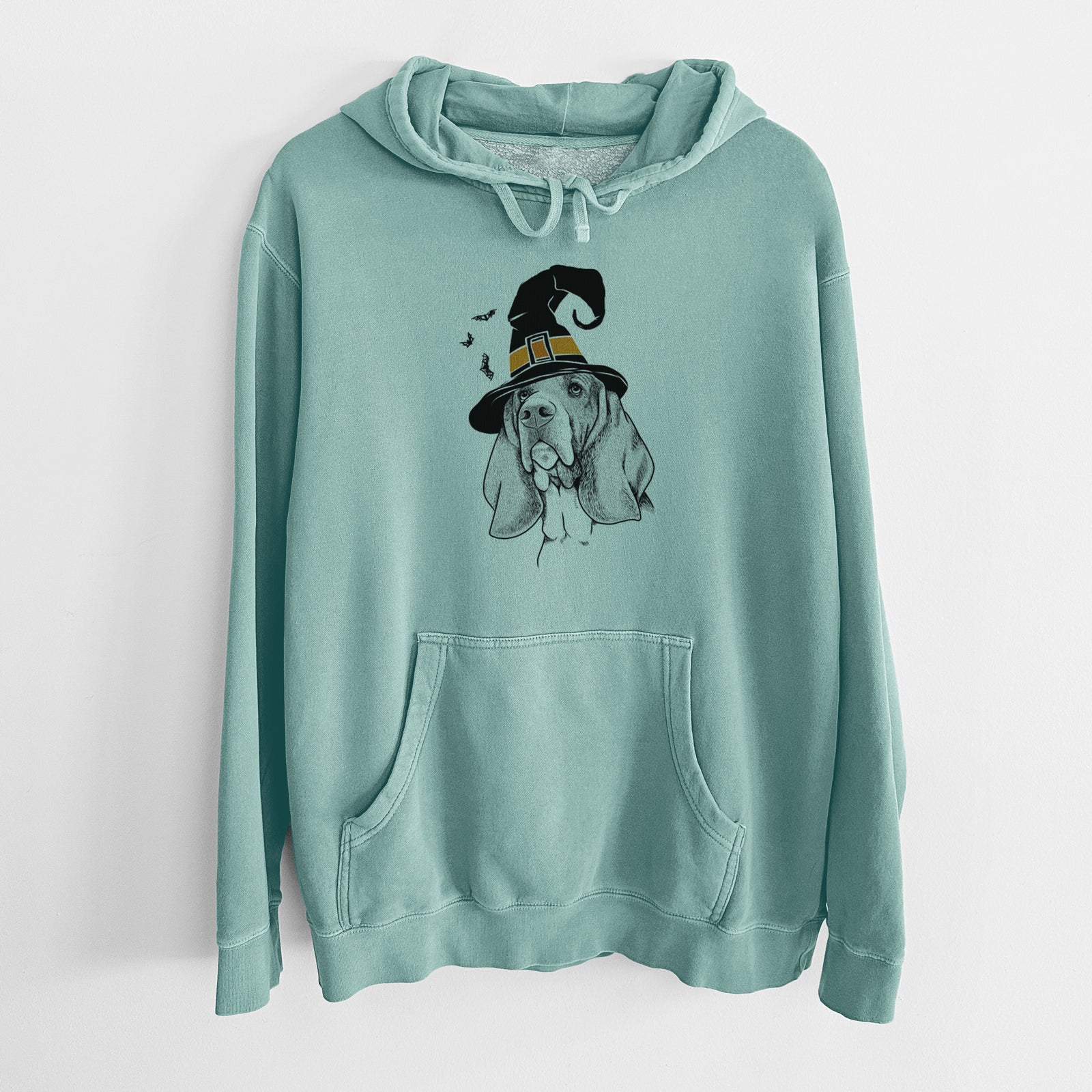 Hand-drawn sketch of Cooper the Basset Hound wearing a witch hat on a Mint Unisex pigment dyed hoodie