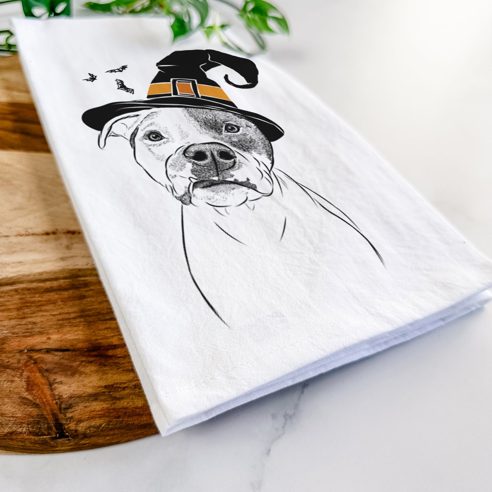 Hand-drawn sketch of Dexter the Pitbull wearing a witch hat on a tea towel