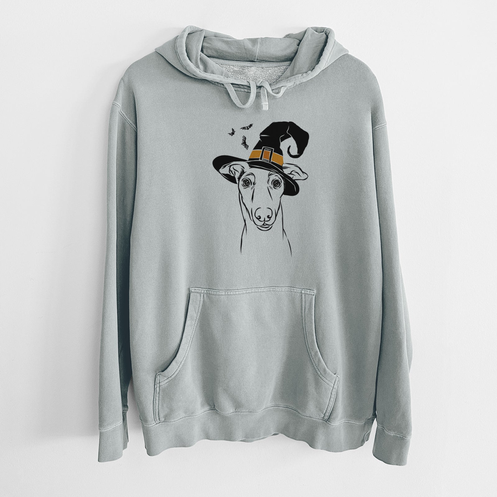 Hand-drawn sketch of Diva the Greyhound wearing a witch hat on a Sage Unisex pigment dyed hoodie