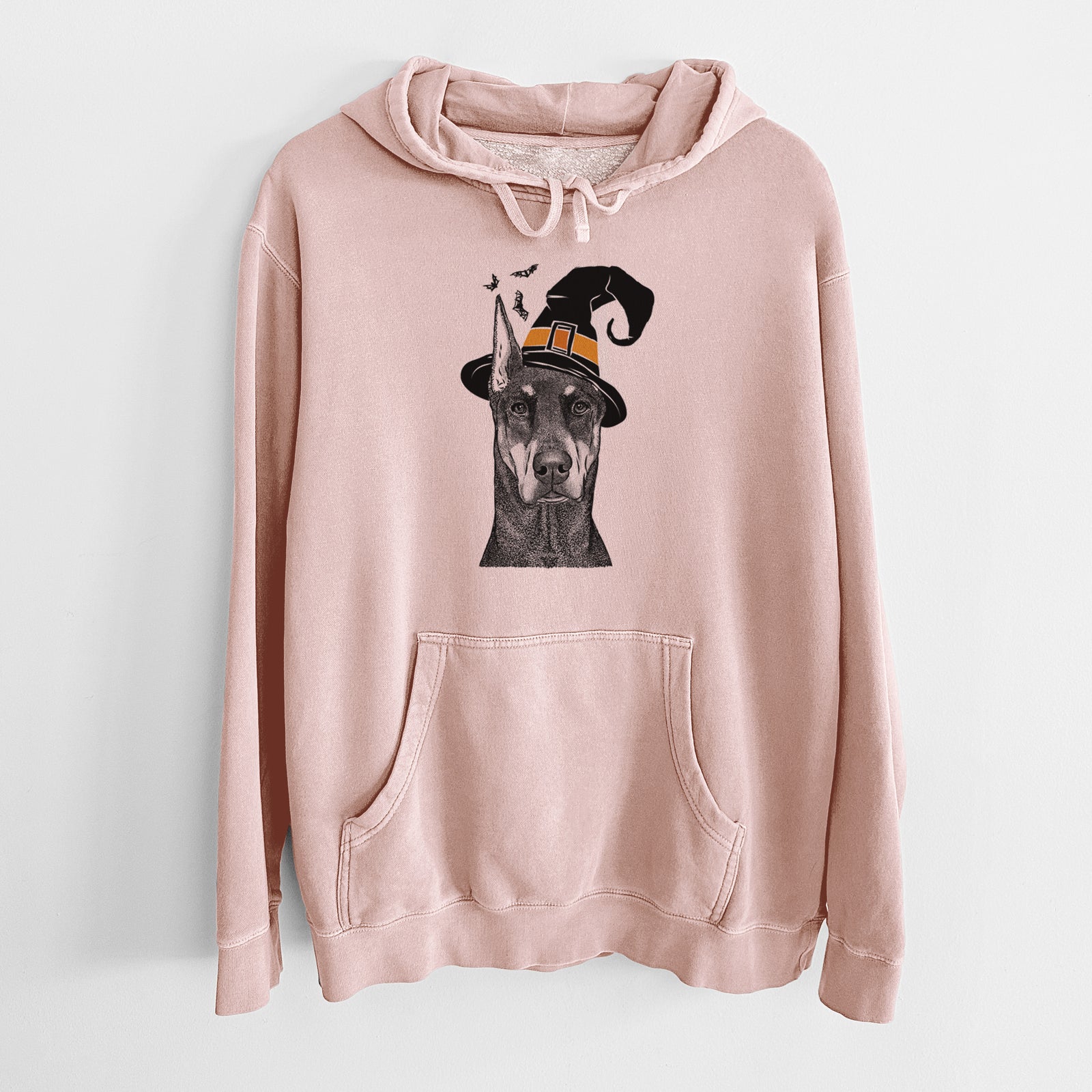 Hand-drawn sketch of Drake the Doberman Pinscher wearing a witch hat on a Dusty Pink Unisex pigment dyed hoodie