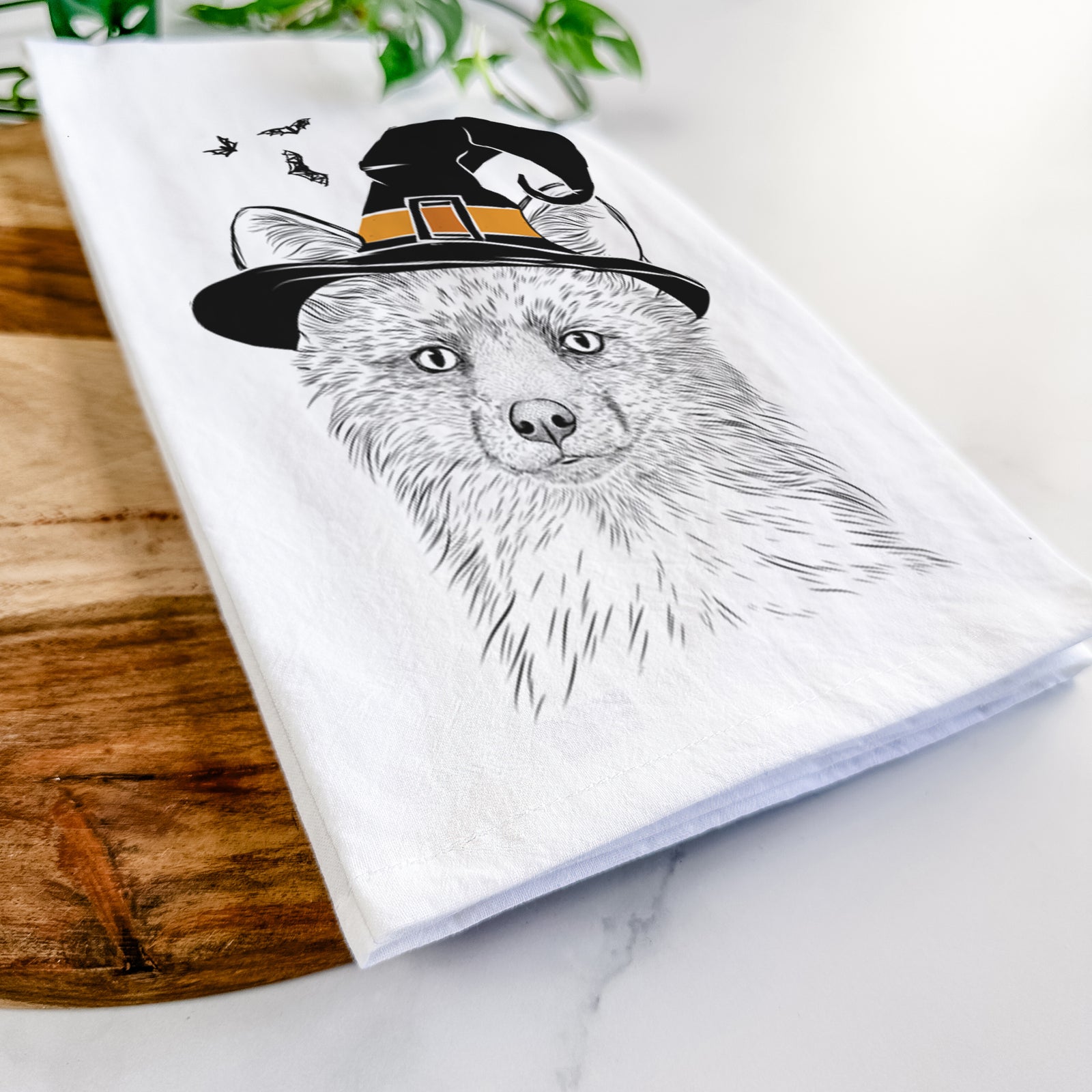 Hand-drawn sketch of Drax the Red Fox wearing a witch hat on a tea towel