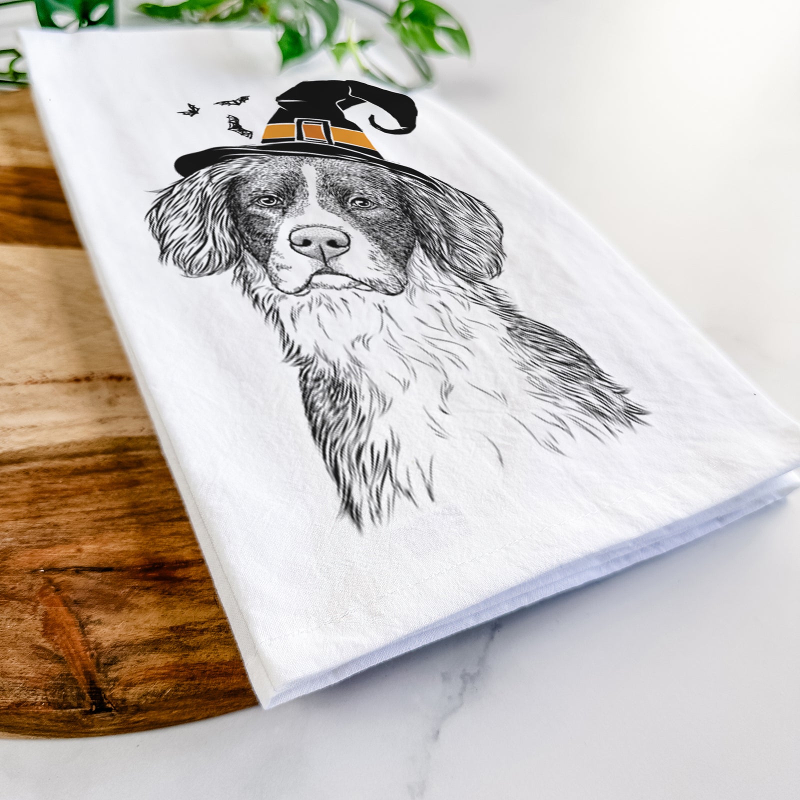 Hand-drawn sketch of Dulce the Drentsche Patrijshond wearing a witch hat on a tea towel