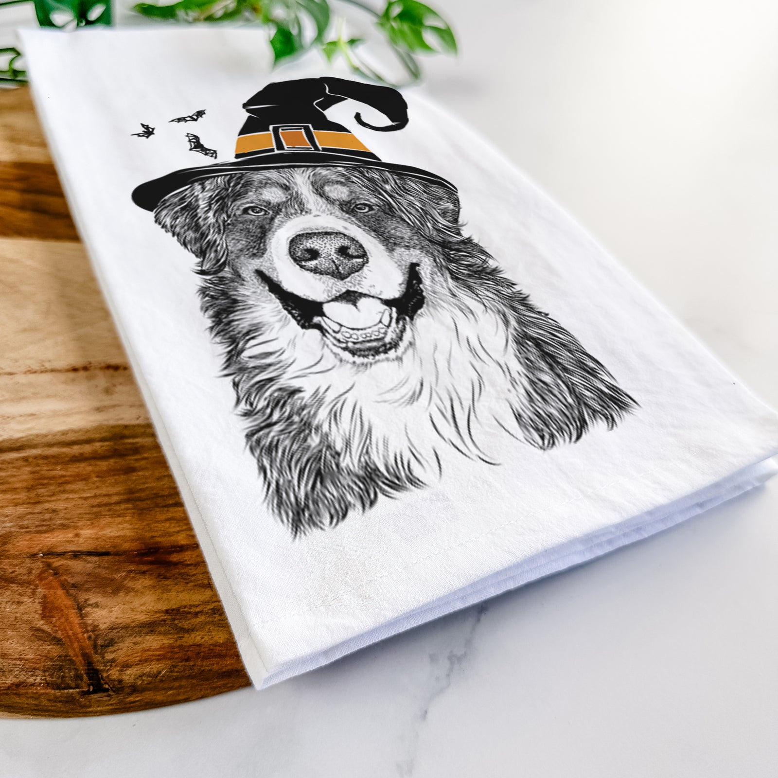 Hand-drawn sketch of Eiger the Bernese Mountain Dog wearing a witch hat on a tea towel