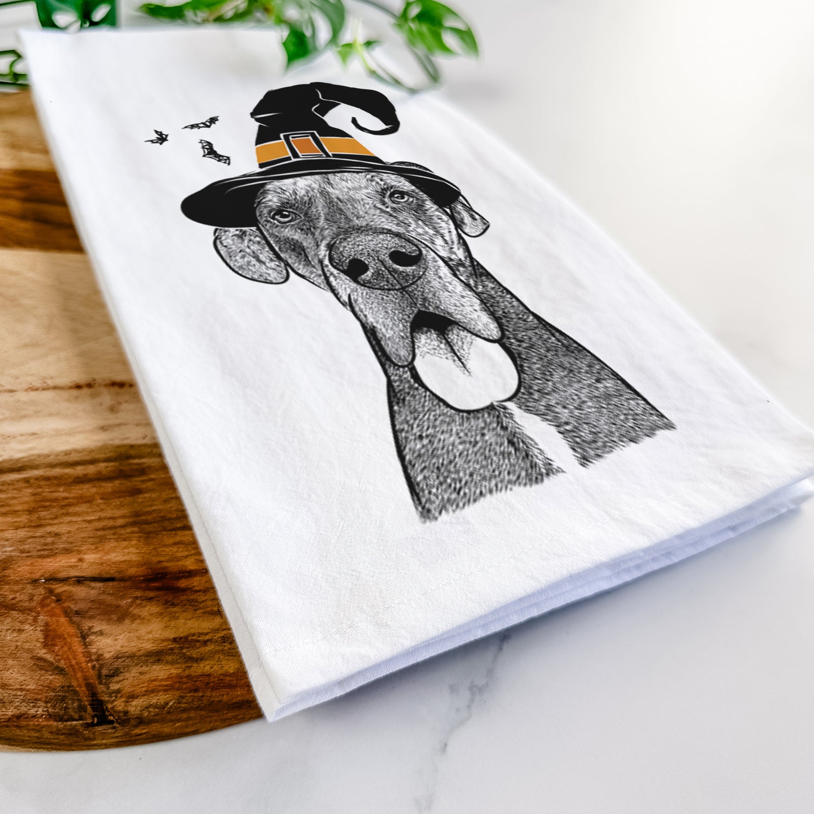 Hand-drawn sketch of Eli the Great Dane wearing a witch hat on a tea towel