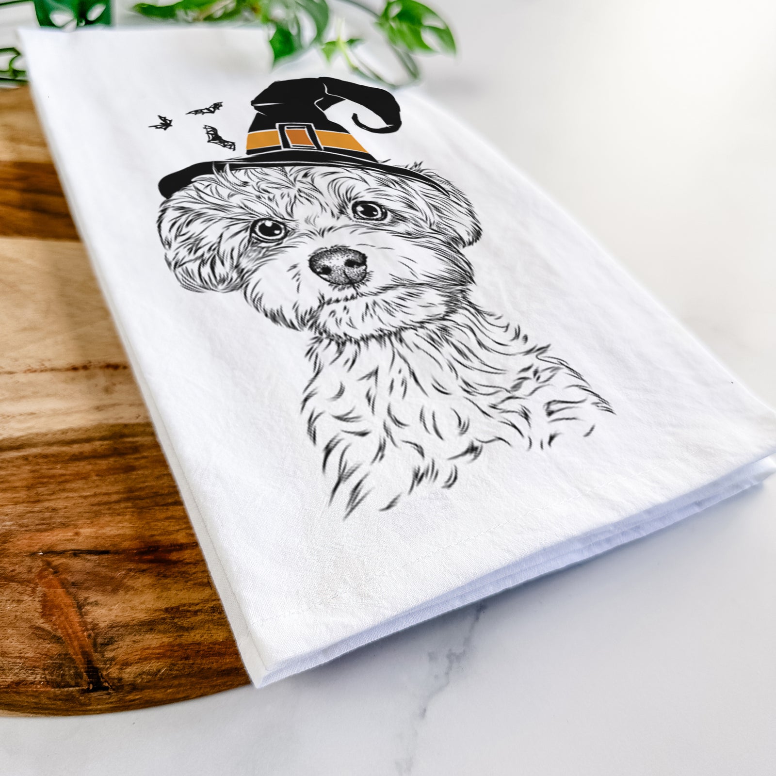 Hand-drawn sketch of Elliott the Yorkiepoo wearing a witch hat on a tea towel