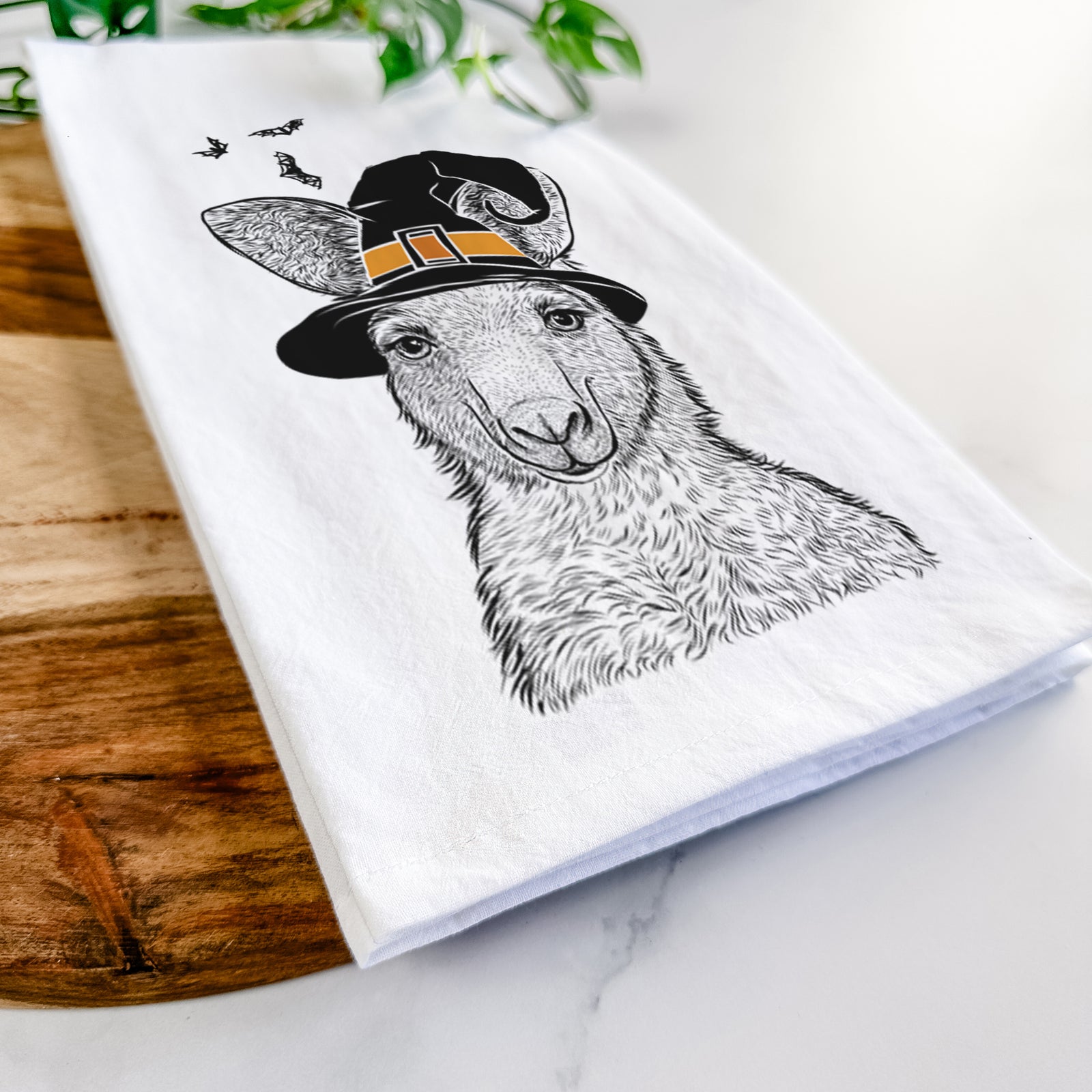 Hand-drawn sketch of Evelyn the Eastern Grey Kangaroo wearing a witch hat on a tea towel