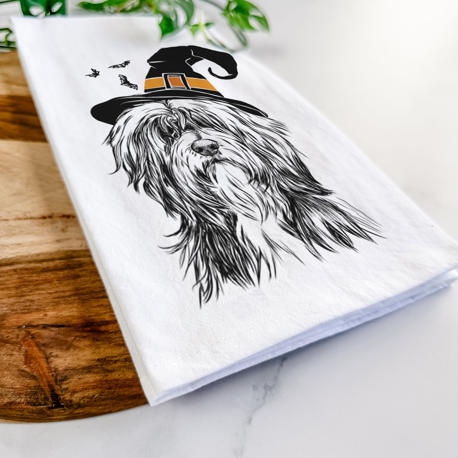 Hand-drawn sketch of Fiji the Polish Lowland Sheepdog wearing a witch hat on a tea towel
