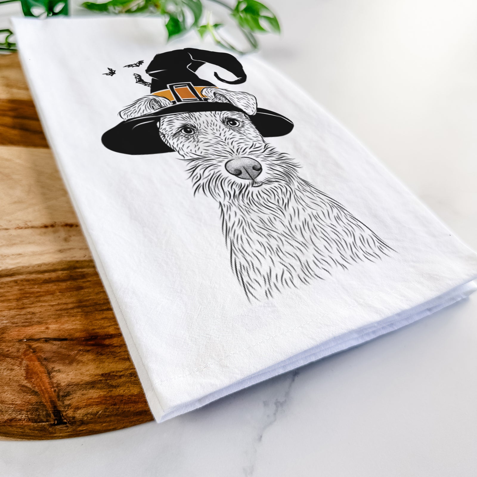 Hand-drawn sketch of Fitz the Wire Fox Terrier wearing a witch hat on a tea towel
