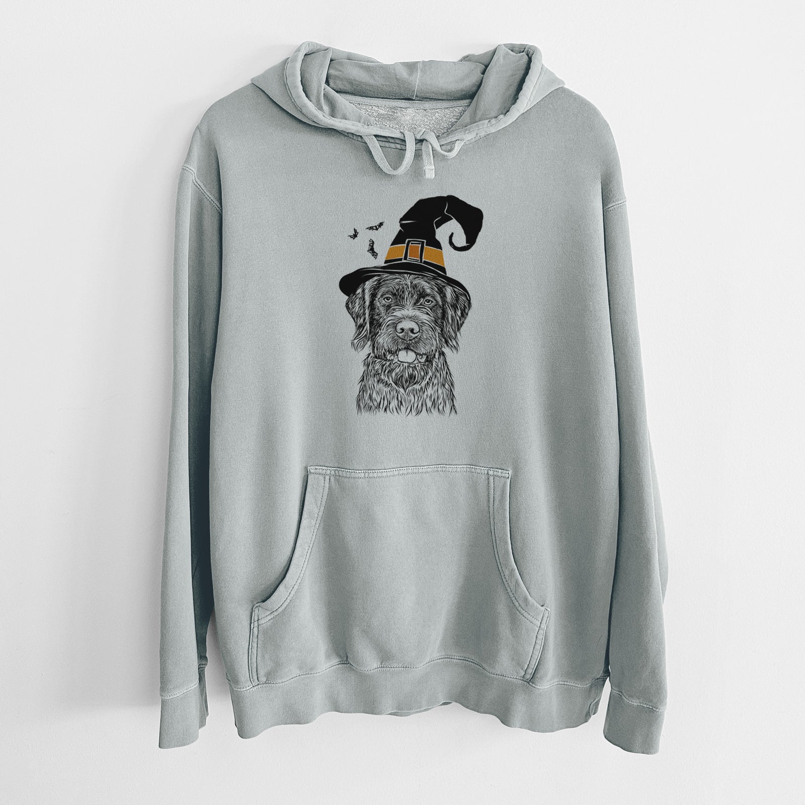 Hand-drawn sketch of Fletcher the Wirehaired Pointing Griffon wearing a witch hat on a Sage Unisex pigment dyed hoodie
