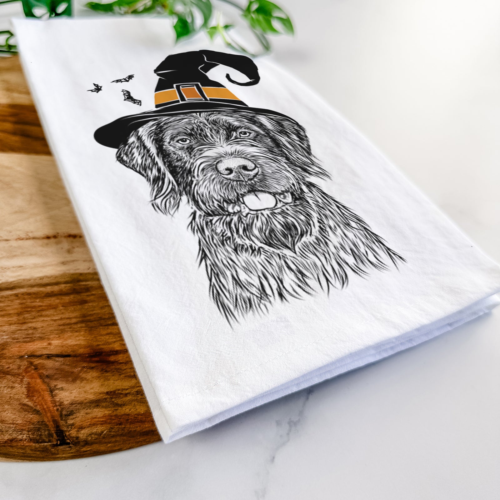 Hand-drawn sketch of Fletcher the Wirehaired Pointing Griffon wearing a witch hat on a tea towel